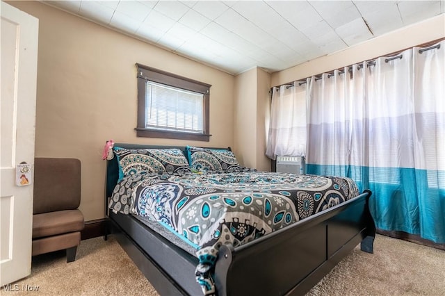 bedroom featuring light carpet