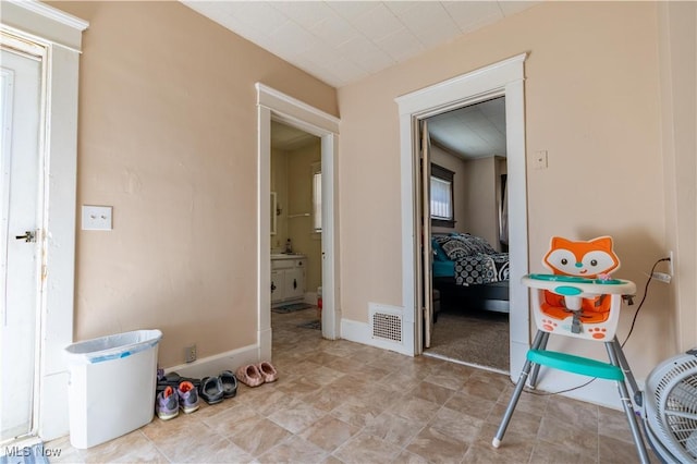 interior space with baseboards and visible vents