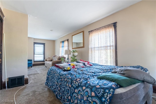 bedroom featuring visible vents and light colored carpet