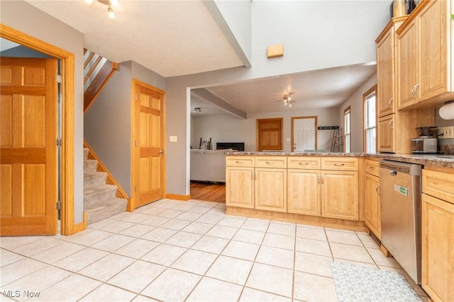 kitchen with light tile patterned floors, light brown cabinets, open floor plan, and dishwasher