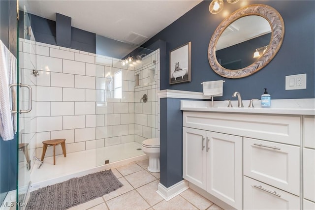 bathroom with toilet, vanity, a walk in shower, and tile patterned floors