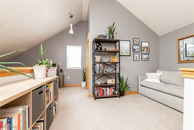 living area with lofted ceiling, carpet, and baseboards