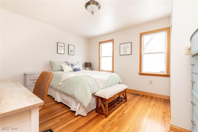 bedroom featuring baseboards and hardwood / wood-style flooring