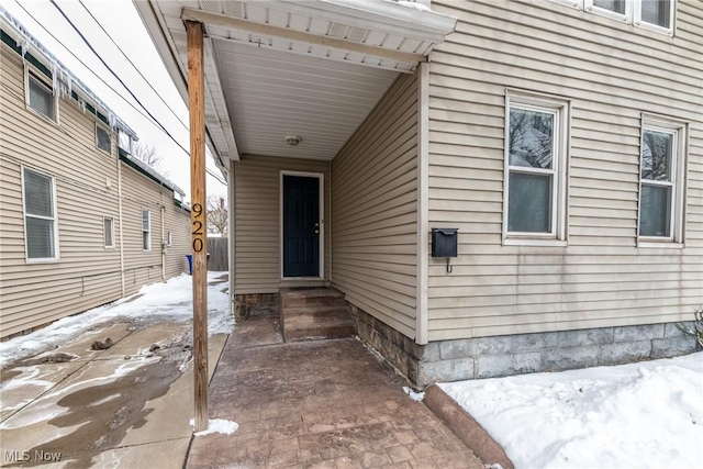 view of snow covered property entrance