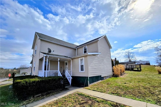 traditional-style home featuring a porch and a front yard