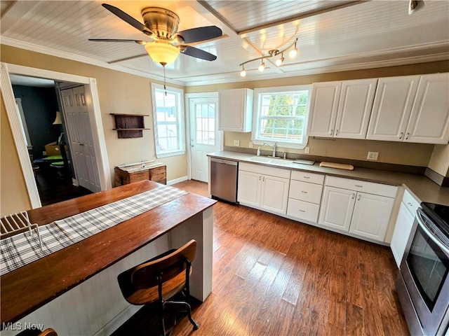 kitchen featuring stainless steel appliances, wood finished floors, and white cabinetry