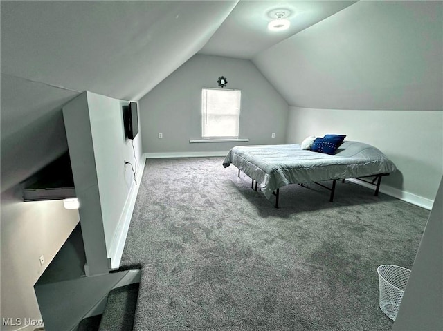 carpeted bedroom featuring baseboards and vaulted ceiling