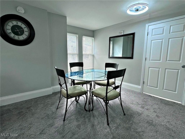 dining room featuring carpet floors and baseboards