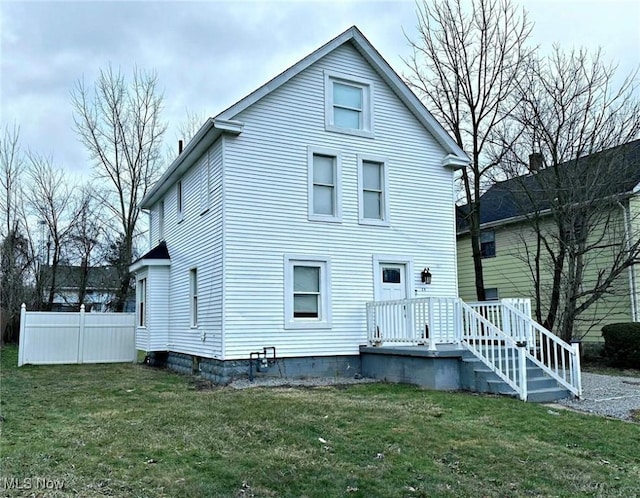 exterior space featuring a front yard and fence