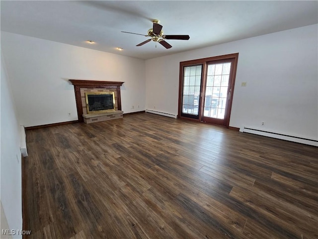 unfurnished living room with a ceiling fan, a baseboard heating unit, dark wood-style flooring, a glass covered fireplace, and baseboard heating