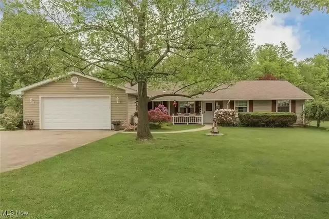 ranch-style home with concrete driveway, an attached garage, and a front yard