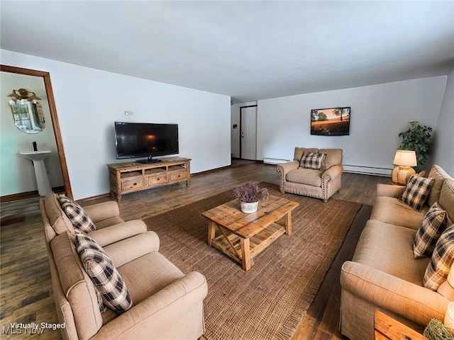 living room featuring wood finished floors, baseboards, and a baseboard radiator