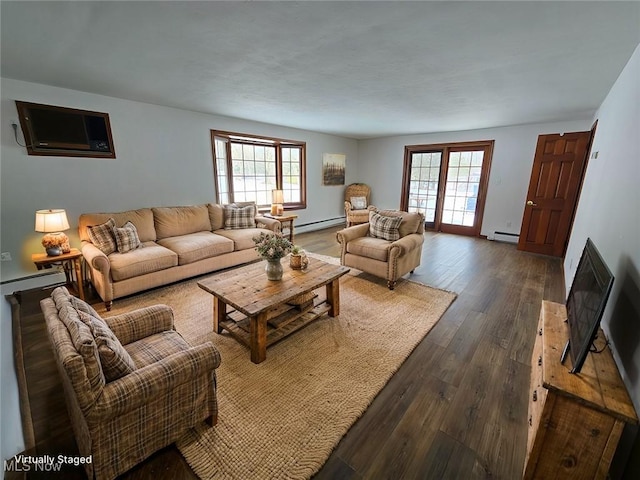 living area featuring a wall mounted air conditioner, a baseboard radiator, plenty of natural light, and dark wood finished floors