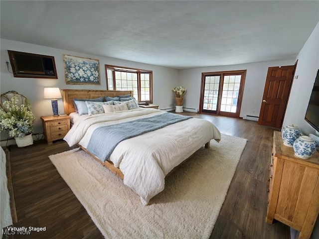 bedroom with multiple windows, a wall mounted air conditioner, a baseboard heating unit, and dark wood-type flooring