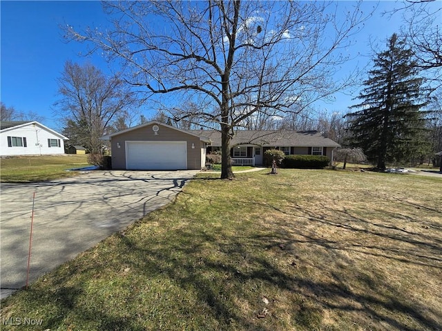 ranch-style home with a garage, driveway, and a front yard