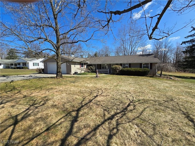 single story home with a garage, driveway, and a front yard