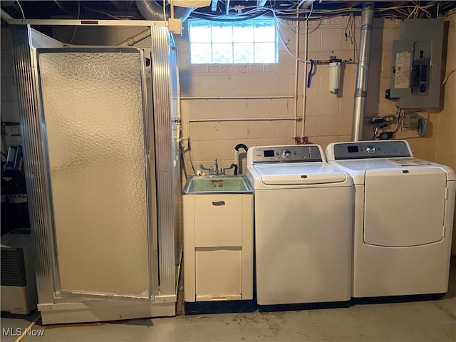 clothes washing area with laundry area, independent washer and dryer, a sink, and electric panel