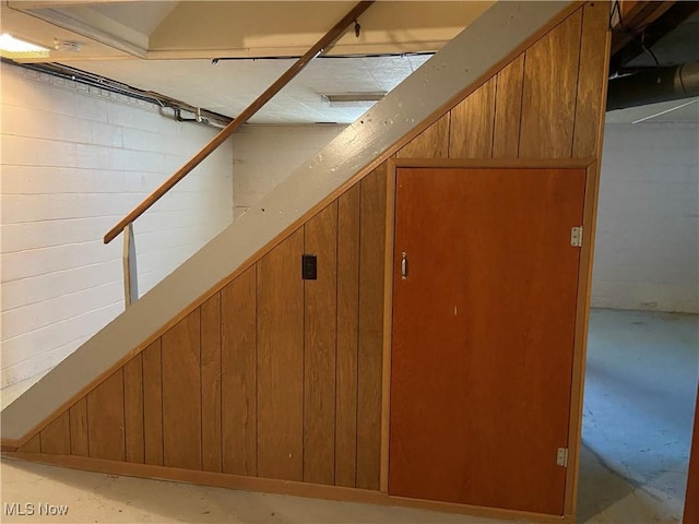 interior space with wooden walls and concrete floors