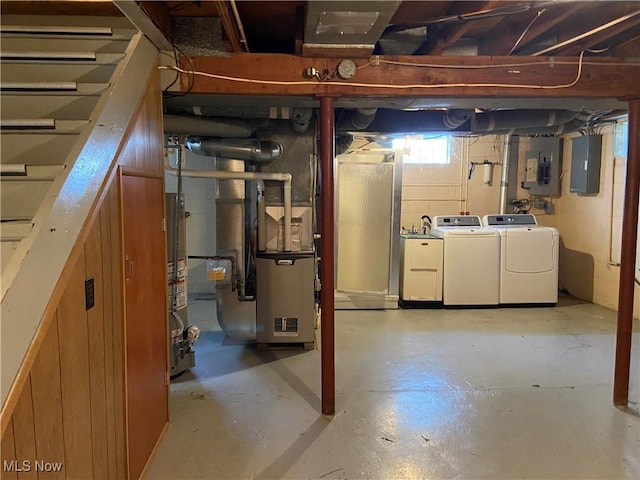 basement featuring separate washer and dryer and electric panel