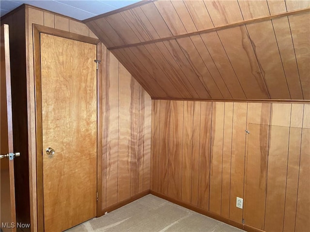 bonus room with vaulted ceiling, wood walls, wood ceiling, and light colored carpet