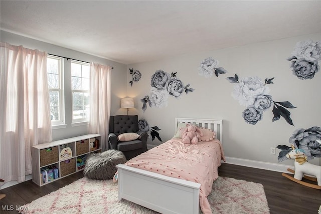 bedroom featuring baseboards and wood finished floors