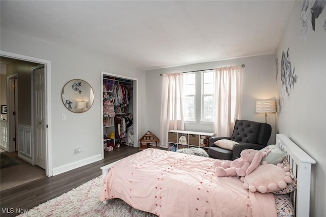 bedroom featuring a closet, baseboards, and wood finished floors