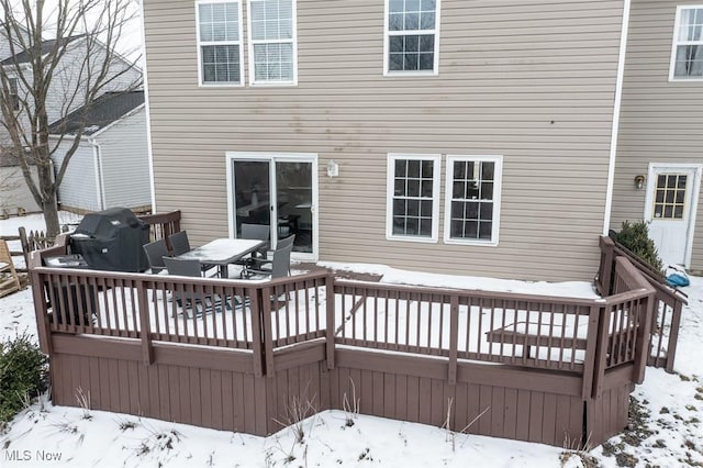 snow covered deck featuring a grill