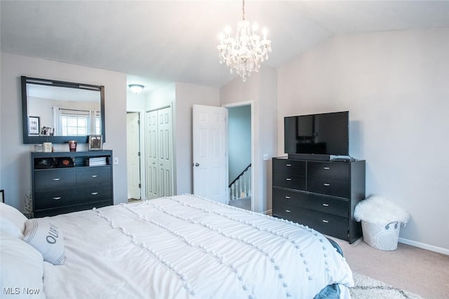 carpeted bedroom with baseboards, vaulted ceiling, and a chandelier