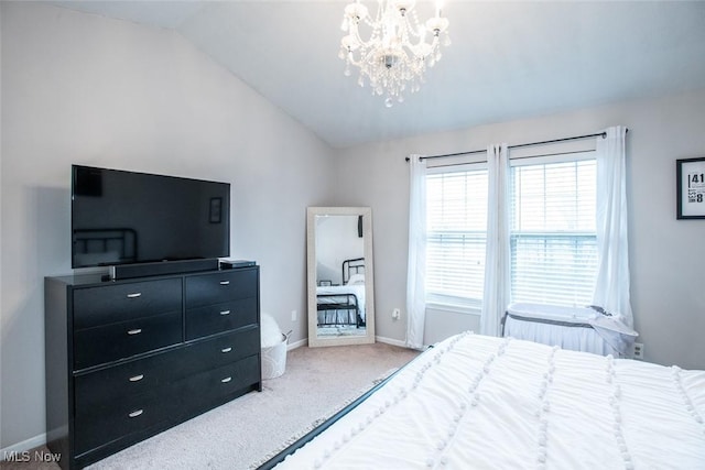 bedroom featuring vaulted ceiling, carpet floors, a chandelier, and baseboards