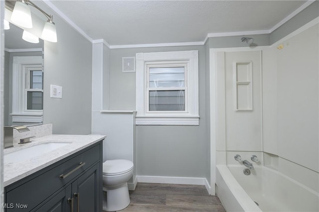 full bath featuring baseboards, toilet, wood finished floors, vanity, and shower / bathing tub combination