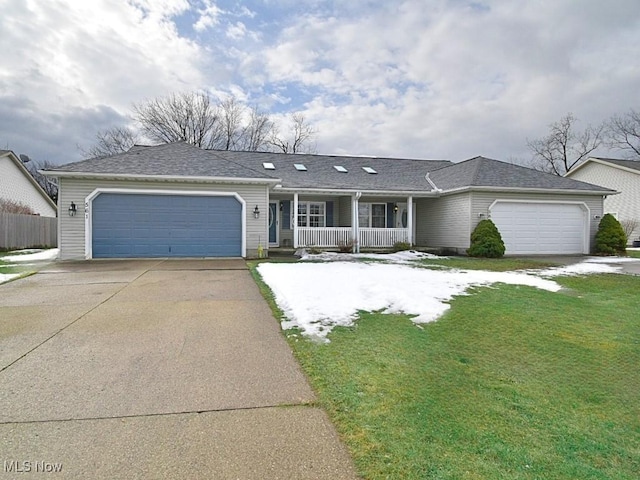 ranch-style home with roof with shingles, a porch, concrete driveway, an attached garage, and a front lawn