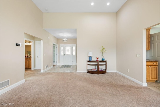 interior space with recessed lighting, light colored carpet, visible vents, and baseboards