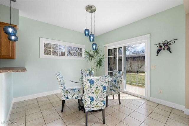 dining space with light tile patterned flooring and baseboards