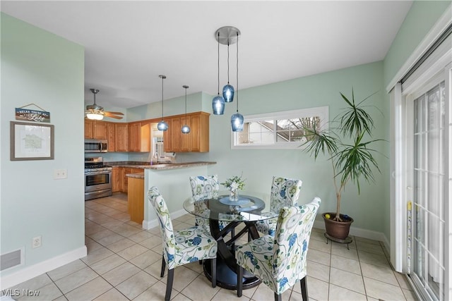 dining area with visible vents, ceiling fan, baseboards, and light tile patterned floors