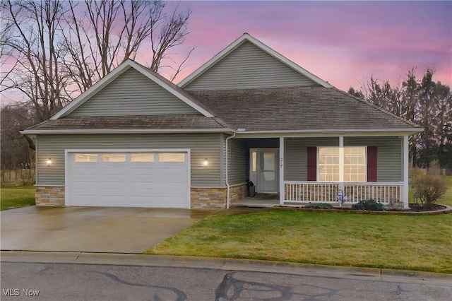 view of front of property with concrete driveway, stone siding, an attached garage, covered porch, and a front lawn