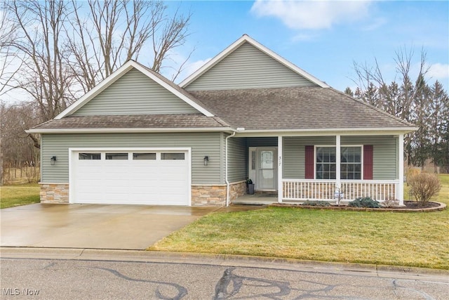 view of front of house with covered porch, stone siding, a front lawn, and a garage