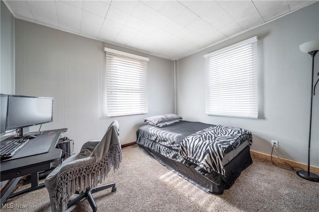 carpeted bedroom featuring baseboards