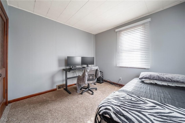 carpeted bedroom featuring baseboards