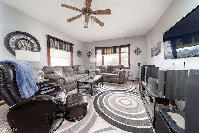 living area with ceiling fan and light carpet