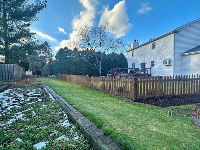 view of yard featuring a fenced backyard and an AC wall unit