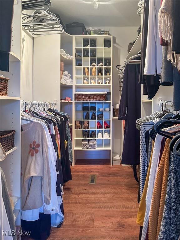 spacious closet featuring wood finished floors