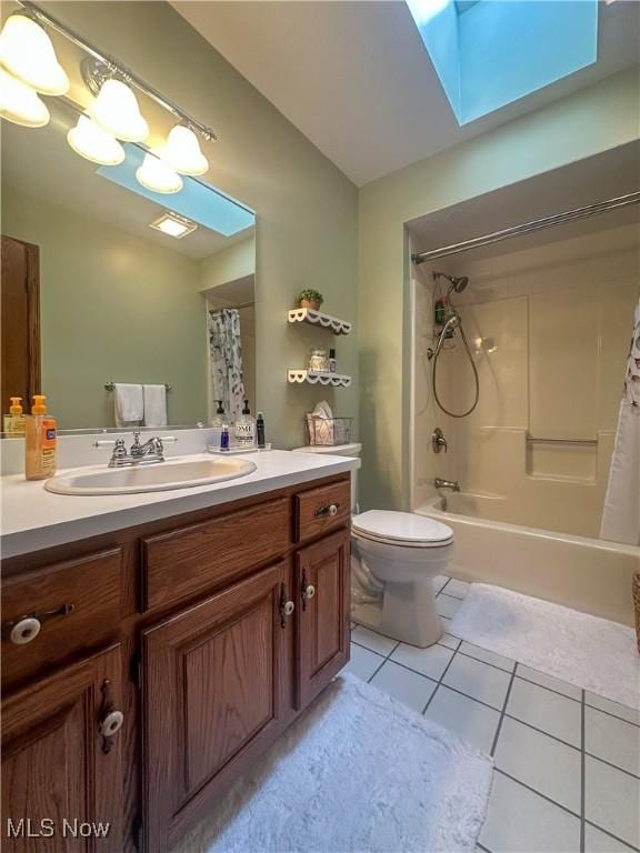 full bathroom featuring toilet, a skylight, tile patterned flooring, and shower / bathtub combination with curtain