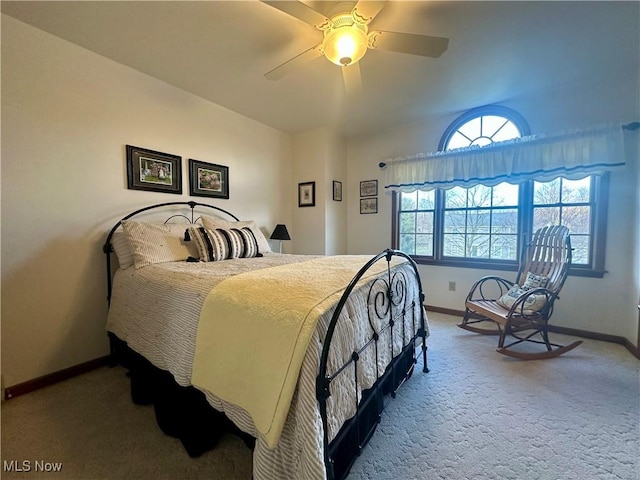 bedroom with a ceiling fan, carpet flooring, and baseboards