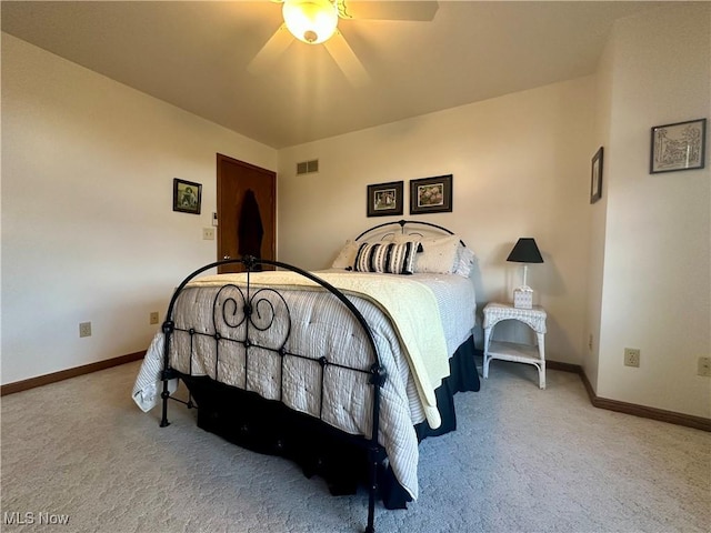 carpeted bedroom with baseboards, visible vents, and ceiling fan