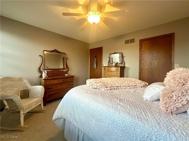 bedroom with carpet, visible vents, and ceiling fan