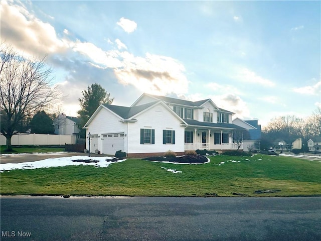 view of front of property featuring a garage, concrete driveway, fence, and a front lawn