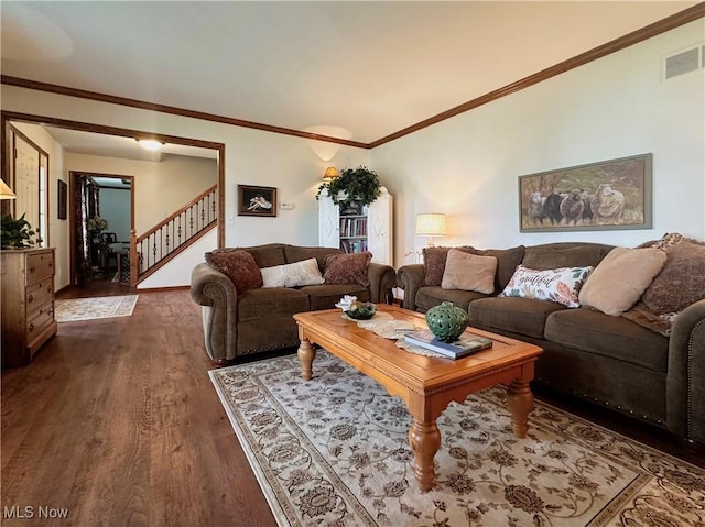 living room featuring dark wood-type flooring, stairway, visible vents, and crown molding