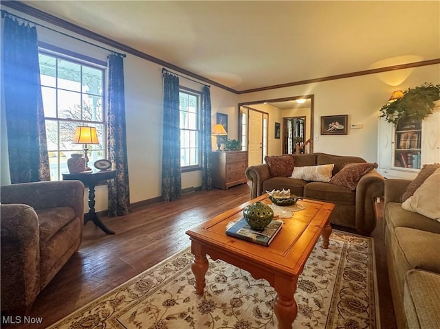 living room featuring a healthy amount of sunlight, baseboards, dark wood finished floors, and crown molding