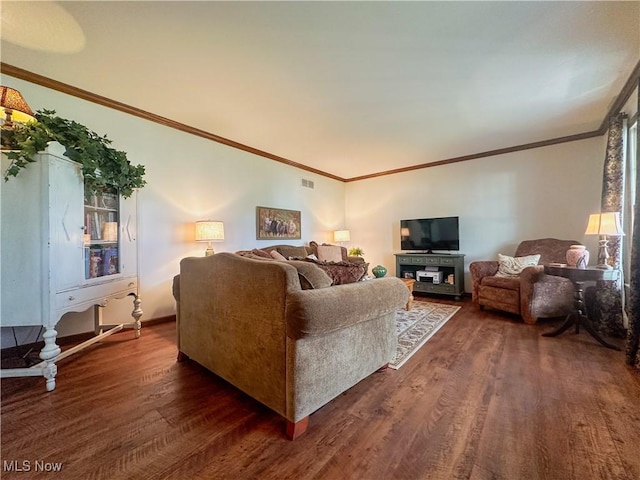 living area with dark wood-style floors, visible vents, and crown molding