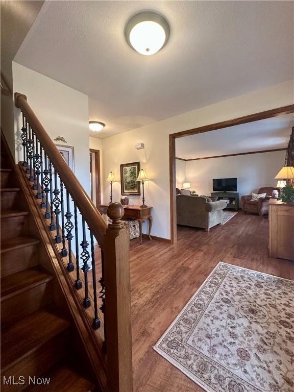 stairway featuring baseboards and wood finished floors